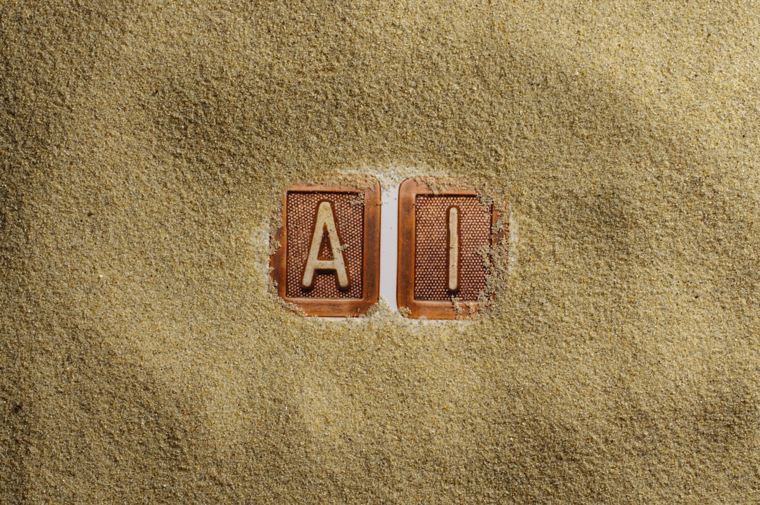 a-close-up-of-a-word-written-in-sand-ltqt12dqpt4